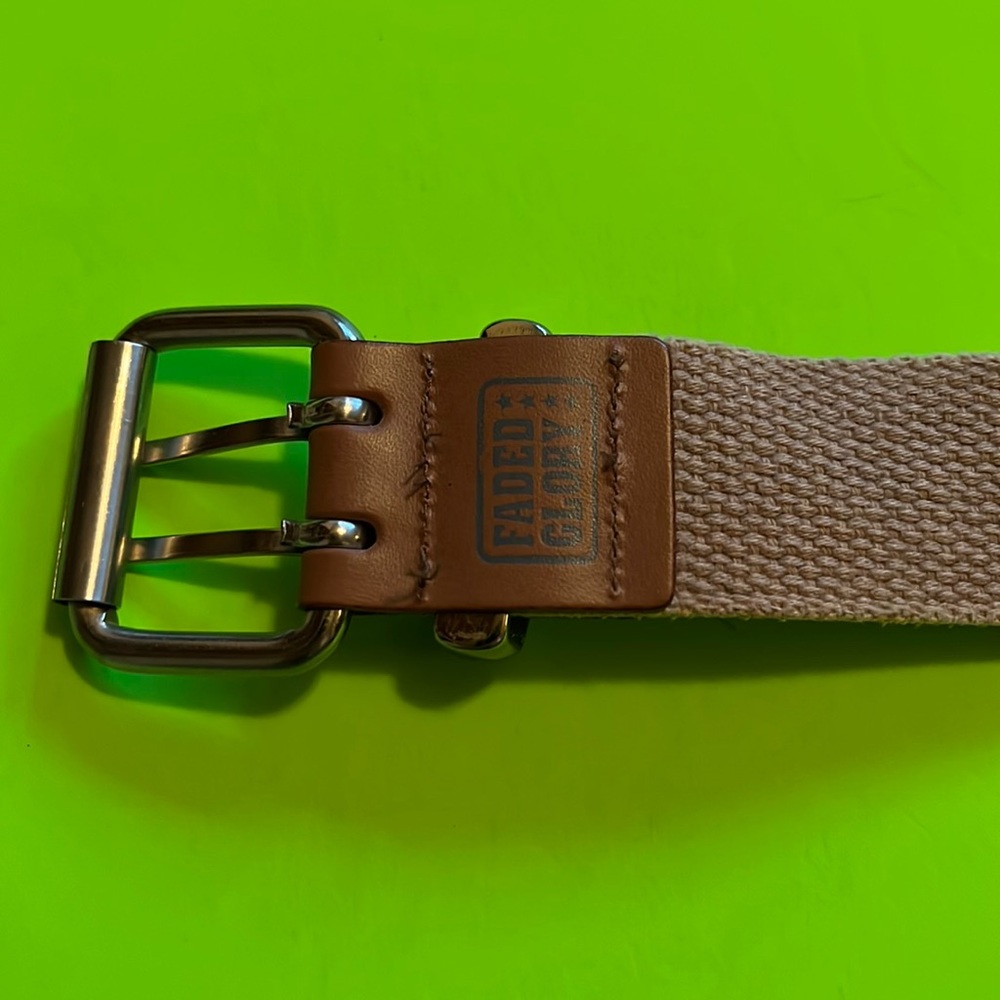Faded glory ladies belt color is tan. Never worn.